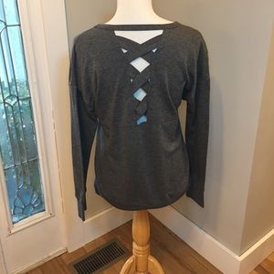 Dark gray long sleeve shirt with V shaped neckline and crisscross back.